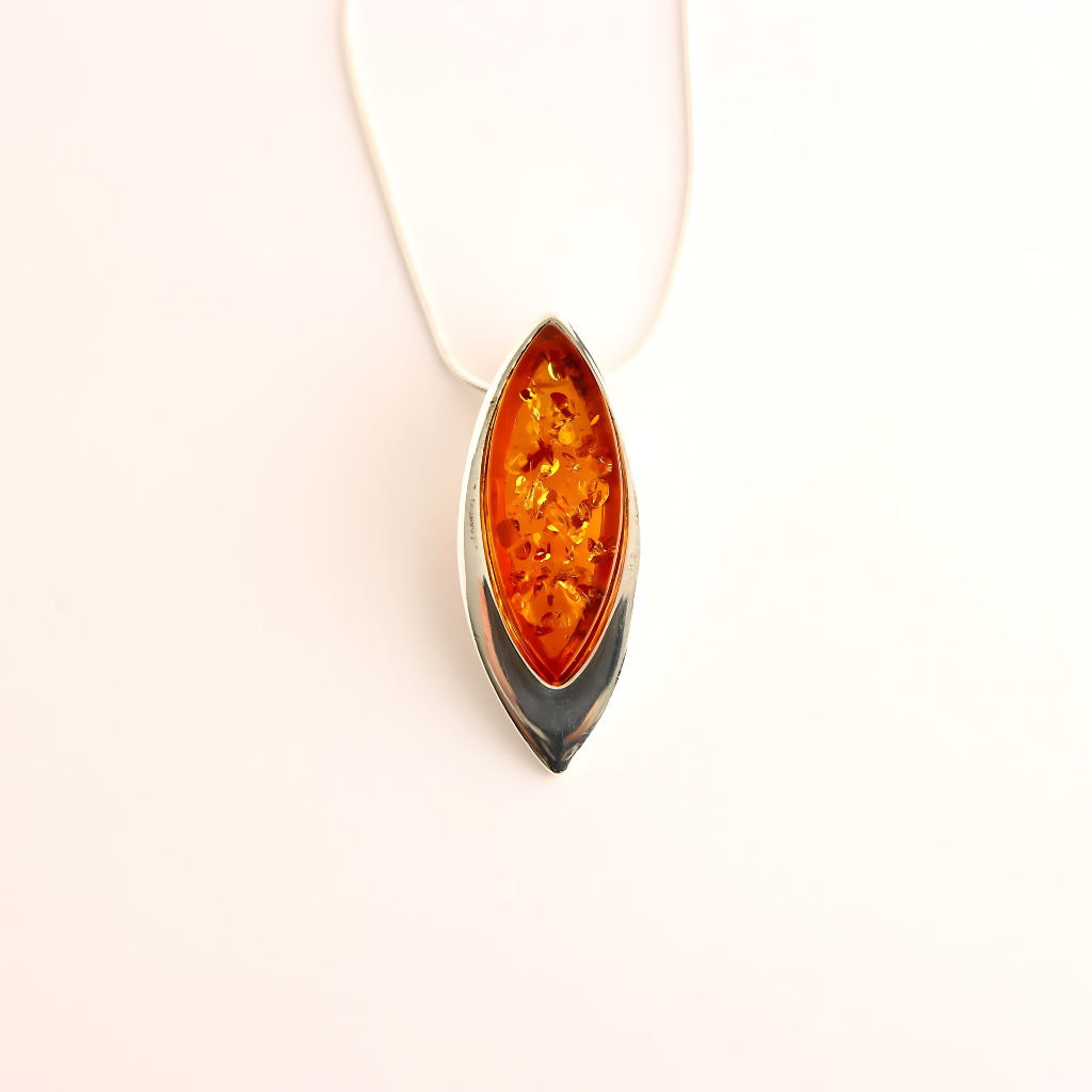 Amber pendant on a white background- sterling silver necklace