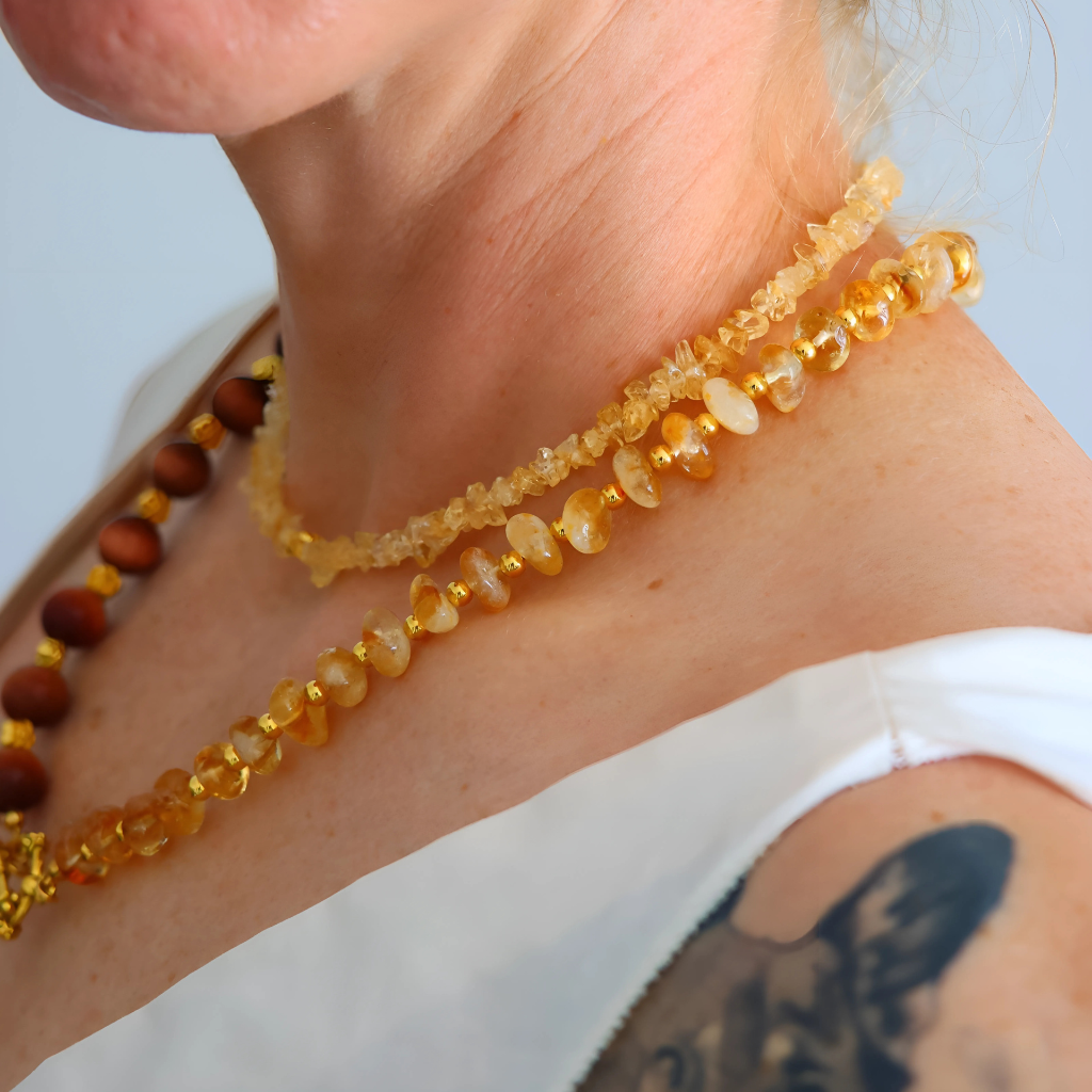 Handmade layered necklace with goldstone and citrine, gold plated beads, gold flower accents, choker and long strand design by Alexis Cintron.