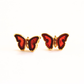 Butterfly-shaped gold stud earrings with red wings and gold frames on a white background