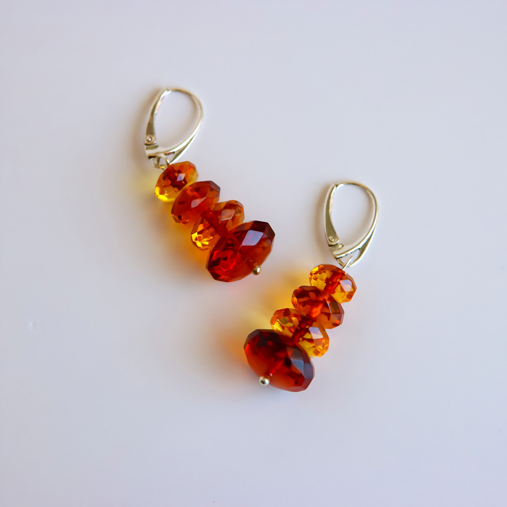 red and orange amber drop earrings on light background