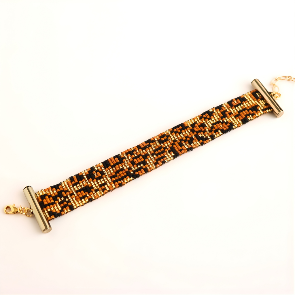 Long rectangular beaded bracelet with a metallic finish on a white background