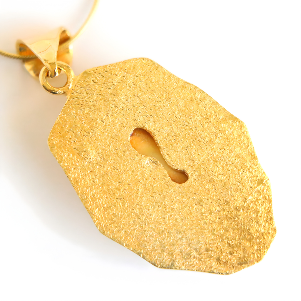 Gold textured amber necklace on a white background