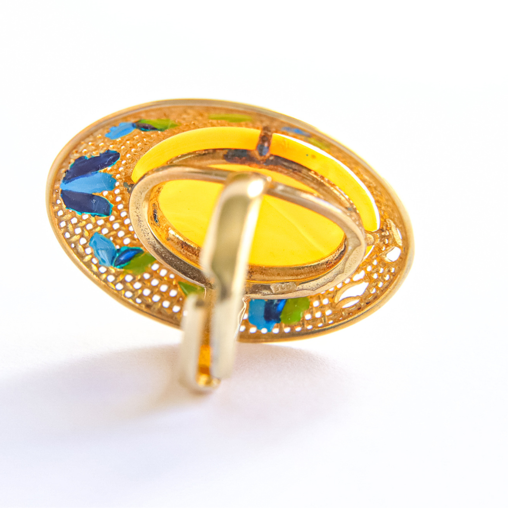 Gold butterscotch amber ring with colorful stones on a white background