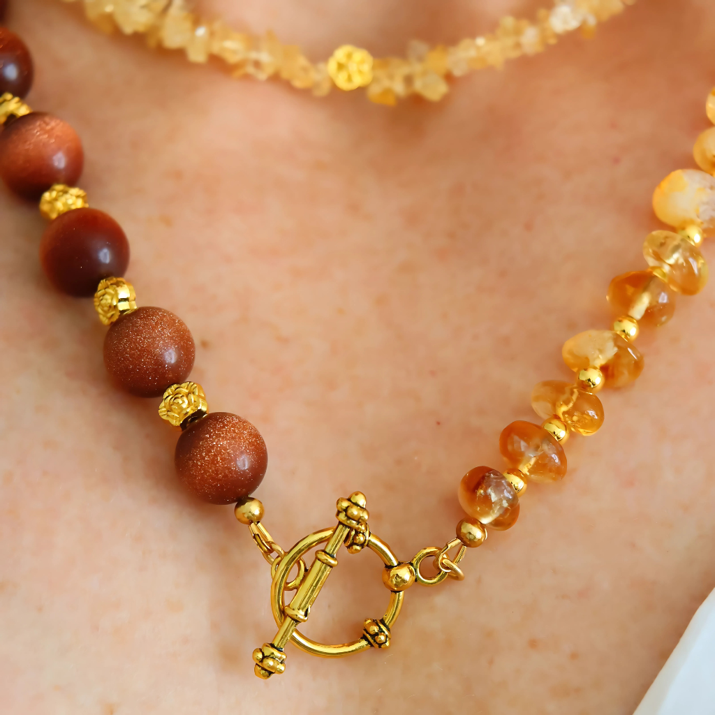 Handmade layered necklace with goldstone and citrine, gold plated beads, gold flower accents, choker and long strand design by Alexis Cintron.