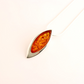 Amber pendant on a thin chain against a white background- sterling silver necklace