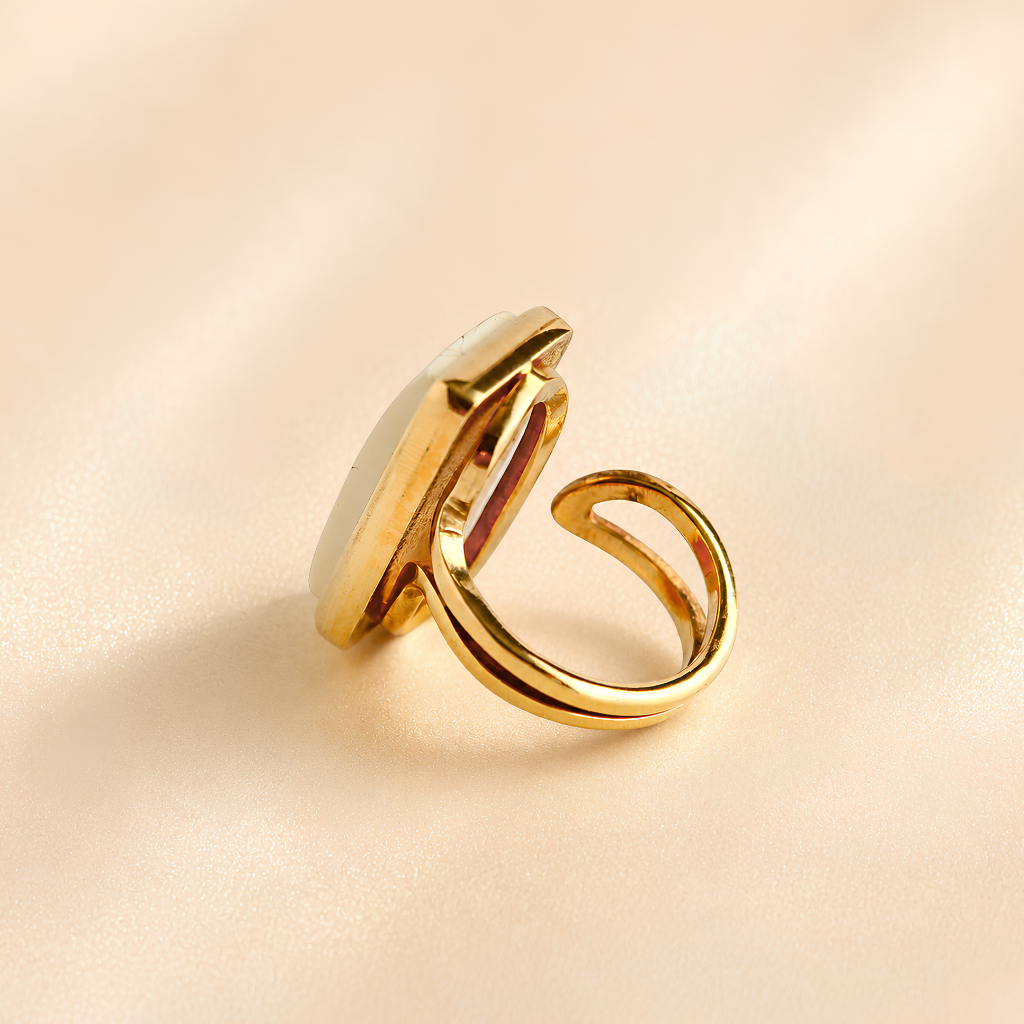 Side view of white amber ring showing raised rectangular setting and adjustable gold-tone band.