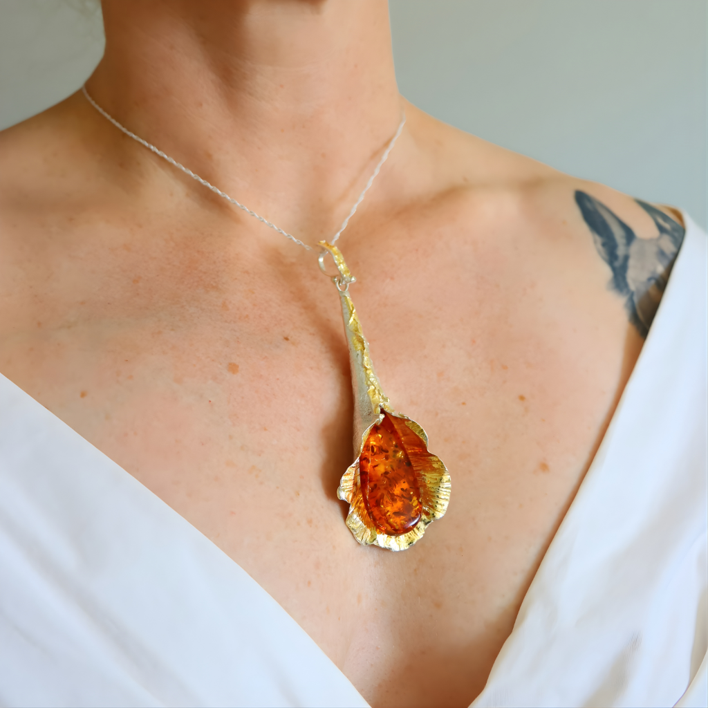 amber Necklace with a large pendant worn by a person