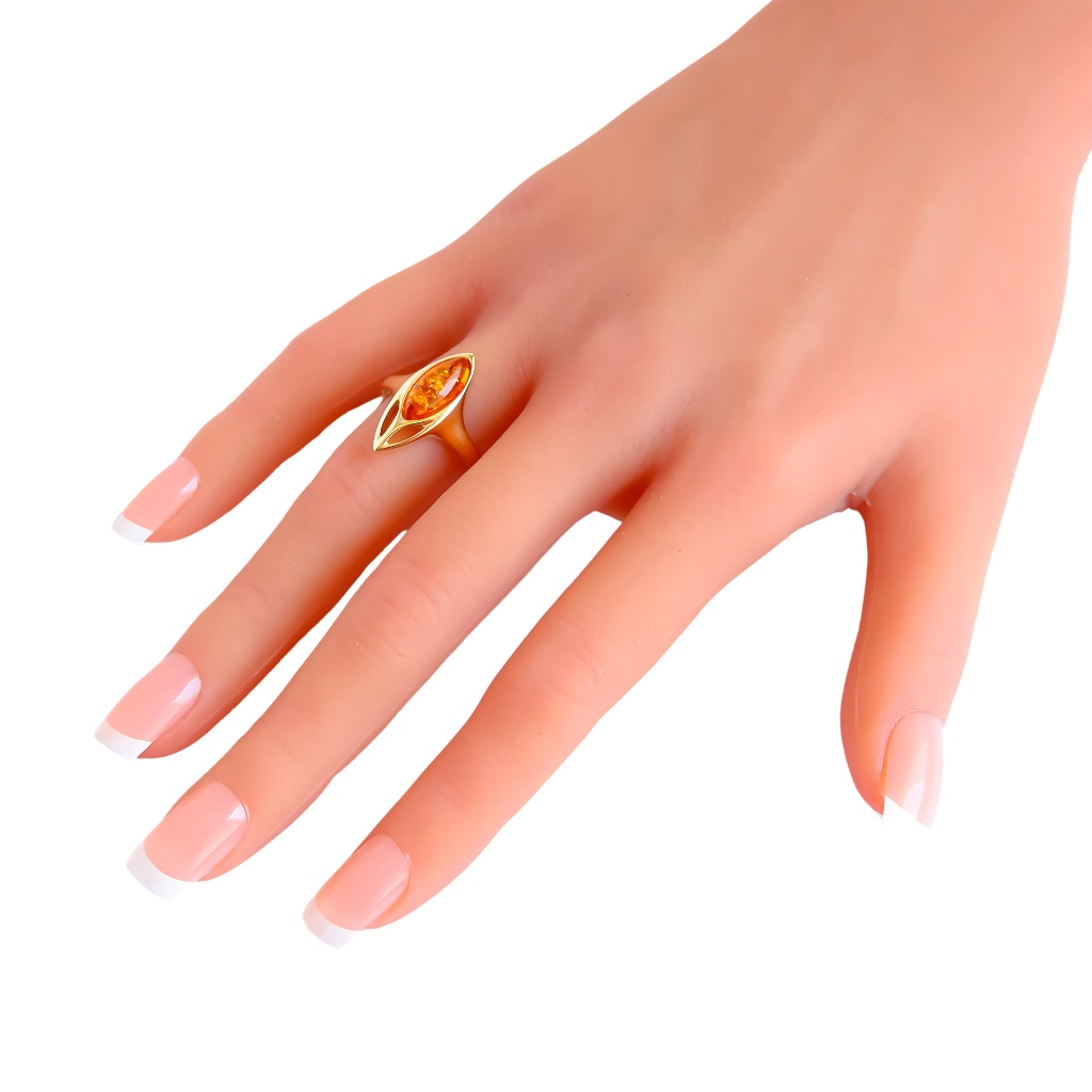 14K gold marquise cut cognac gold amber ring on hand, showcasing Baltic amber and modern design.