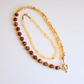 Handmade layered necklace with goldstone and citrine, gold plated beads, gold flower accents, choker and long strand design by Alexis Cintron.