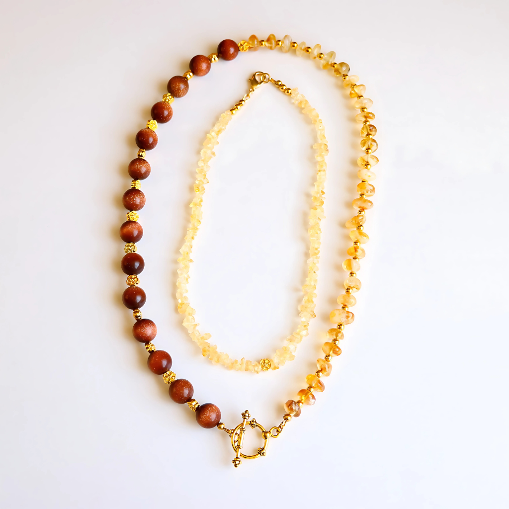 Handmade layered necklace with goldstone and citrine, gold plated beads, gold flower accents, choker and long strand design by Alexis Cintron.