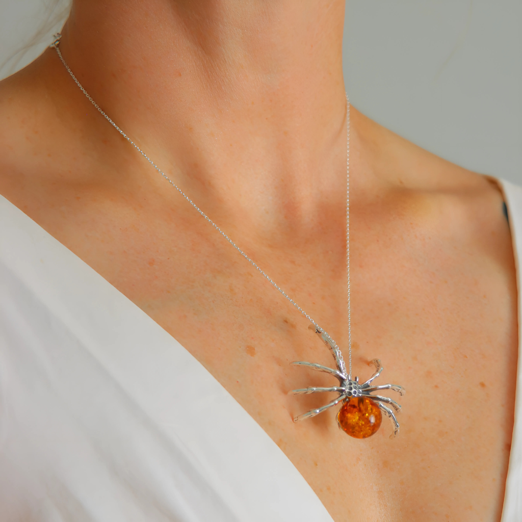amber Necklace with a spider pendant featuring an amber stone on a neutral background