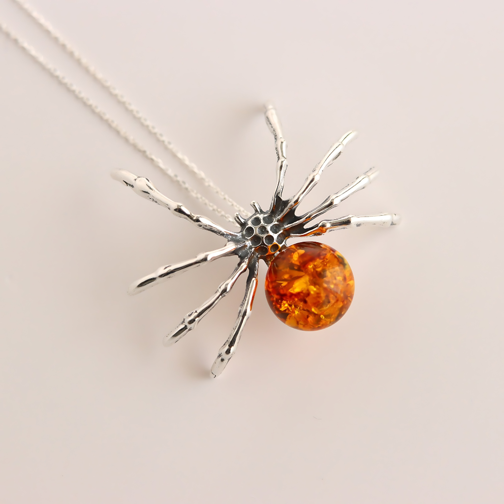 Amber Necklace with Spider-shaped pendant central amber stone on a light background