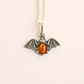 amber necklace with Silver bat pendant with amber stone on a white background