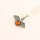 amber necklace with bat pendant amber stone on a white background