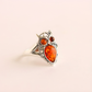 Silver amber ring with amber stones on a beige background
