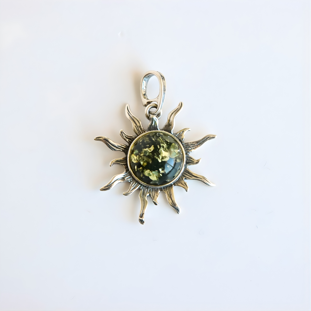 amber Sun pendant with a green gemstone on a white background