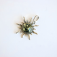 Amber Sun pendant with green gemstone on a white background
