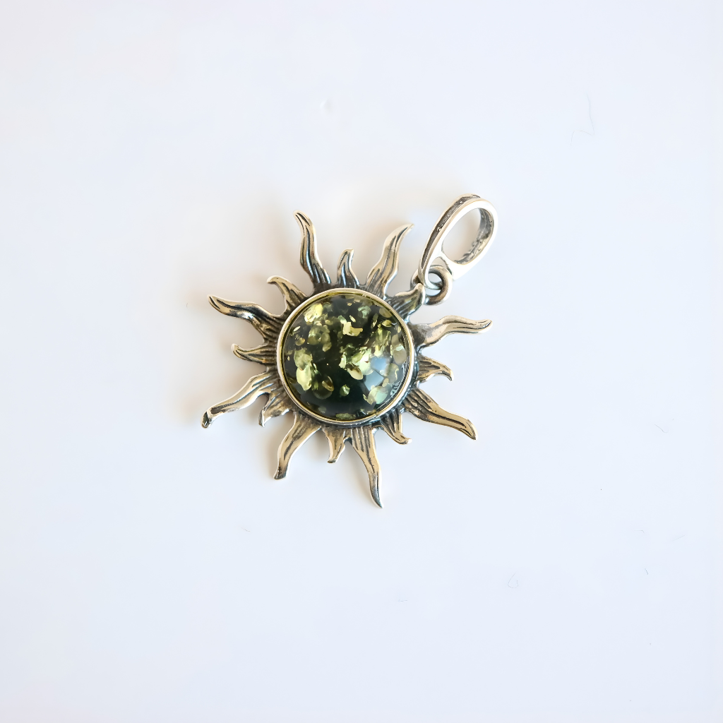 Amber Sun pendant with green gemstone on a white background