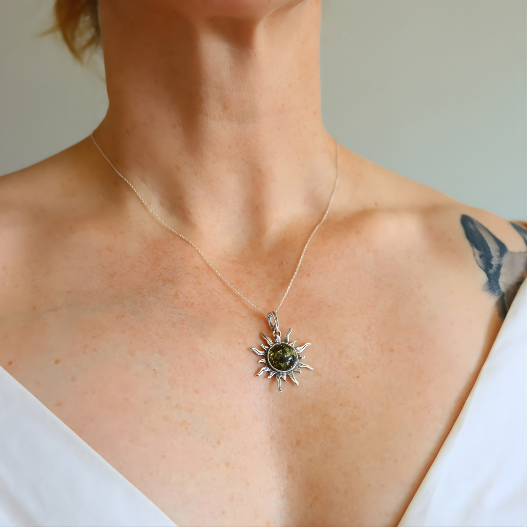 Necklace with a amber sun pendant worn by a person