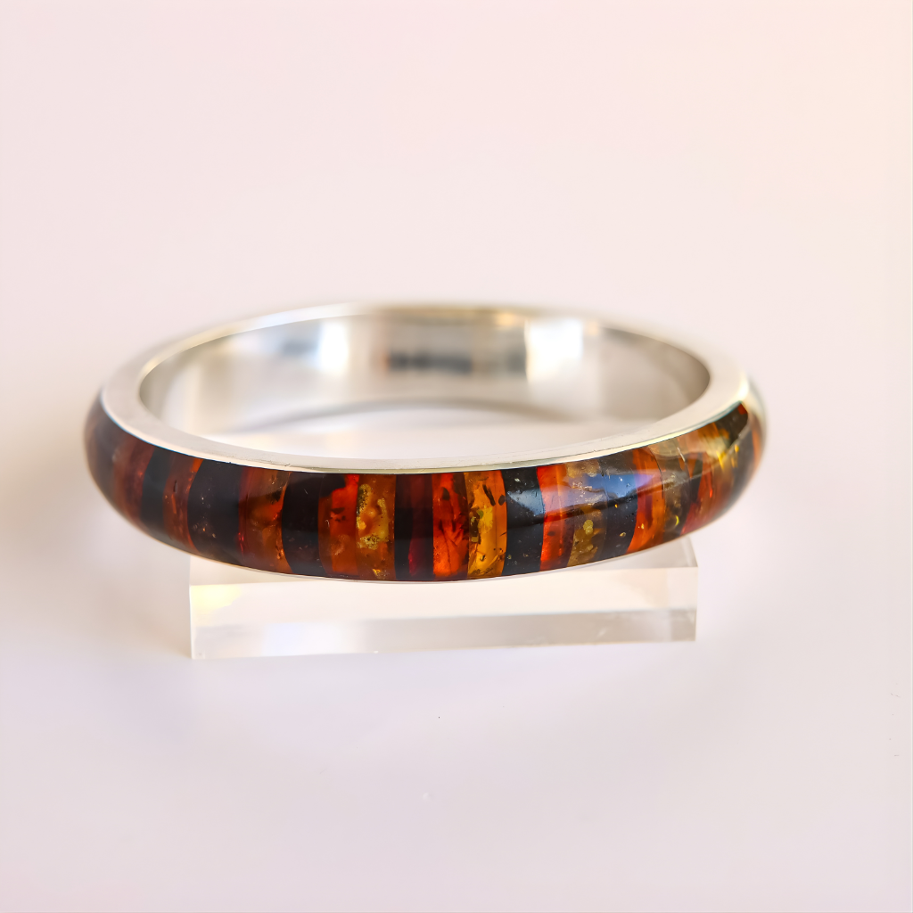 amber Bangle bracelet with multicolored striped pattern on a white background