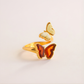 Gold butterfly ring design on a light background