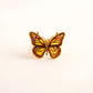 Butterfly Ring with gold frame and orange wings on a white background