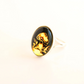 mushroom ring with black amber stone featuring a engraved design on a white background