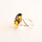 Silver mushroom ring with a large amber stone on a light background