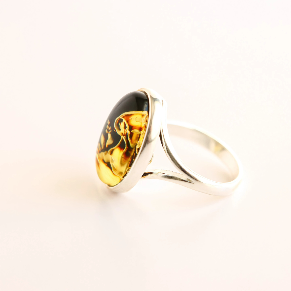 Silver mushroom ring with a large amber stone on a light background