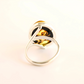 silver mushroom ring with a black stone on a white background