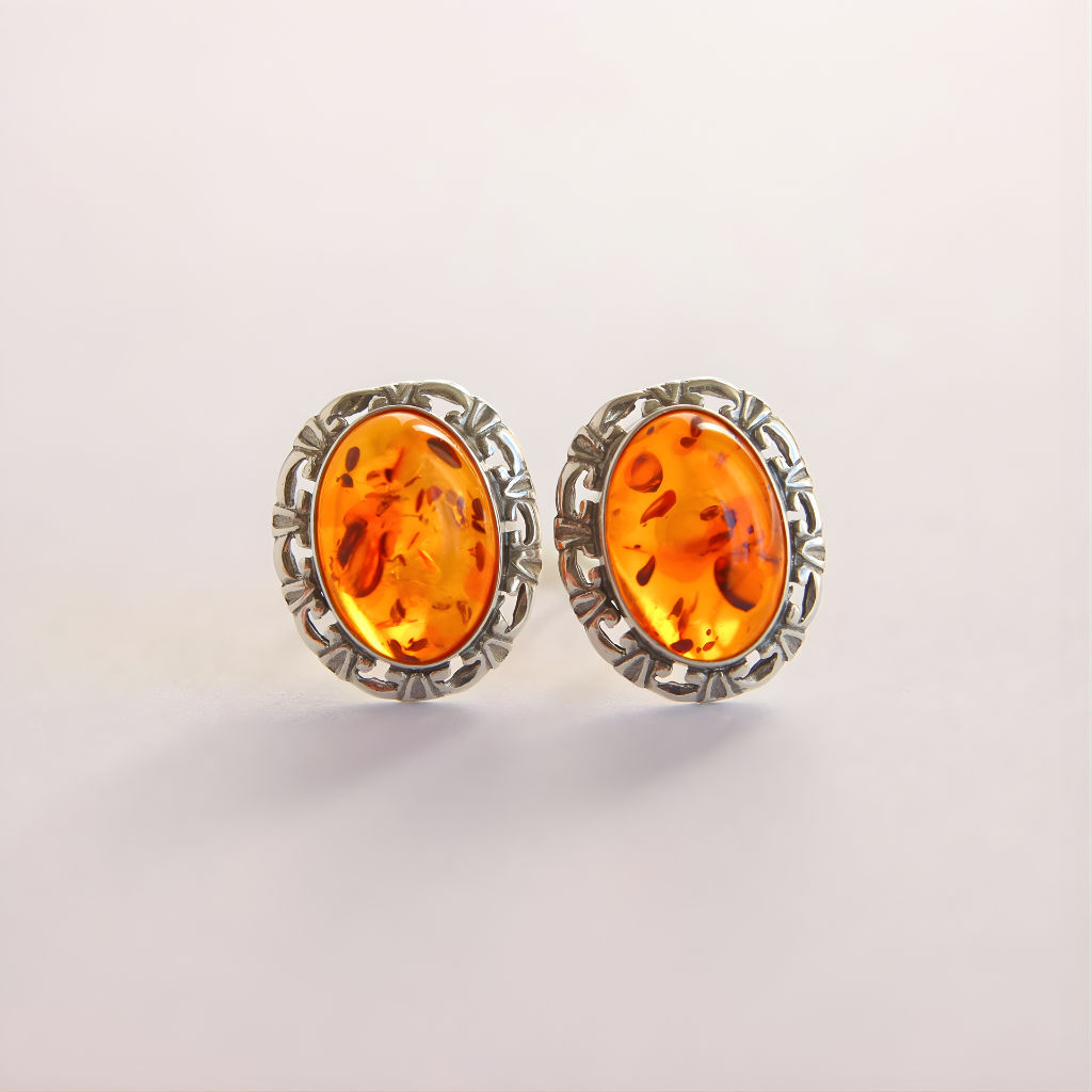 Pair of amber clip on earrings on a light gray background
