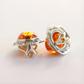 Silver clip on earrings with amber stones on a light background