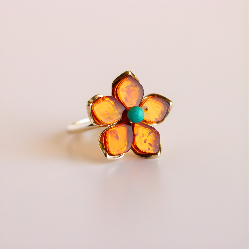 Flower  ring with amber-colored petals and a turquoise center on a light background