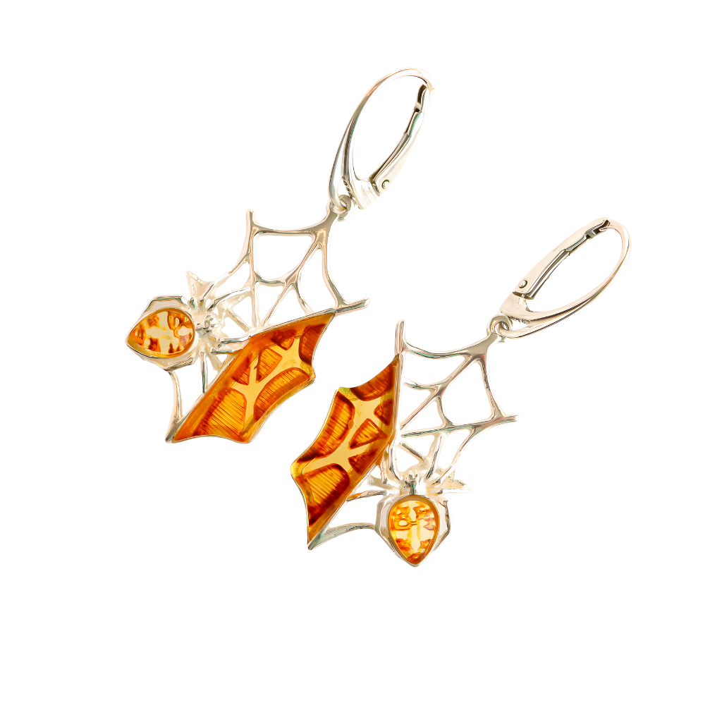 Baltic amber spiderweb dangle earrings in 925 sterling silver with intricate laser-cut design.