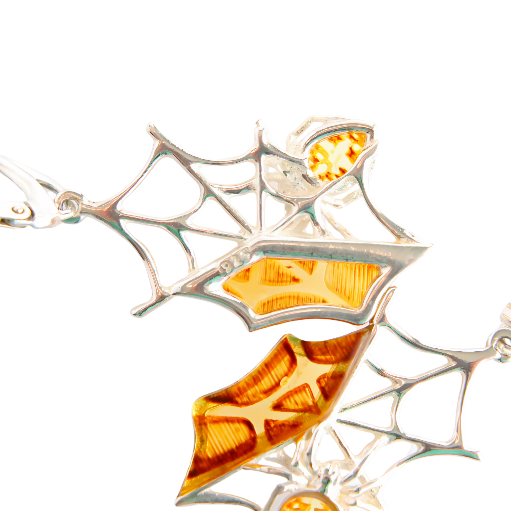 Handmade Baltic amber spiderweb earrings in 925 sterling silver with intricate design.