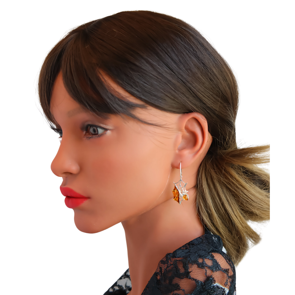 Baltic amber spiderweb dangle earrings in 925 sterling silver on a model.
