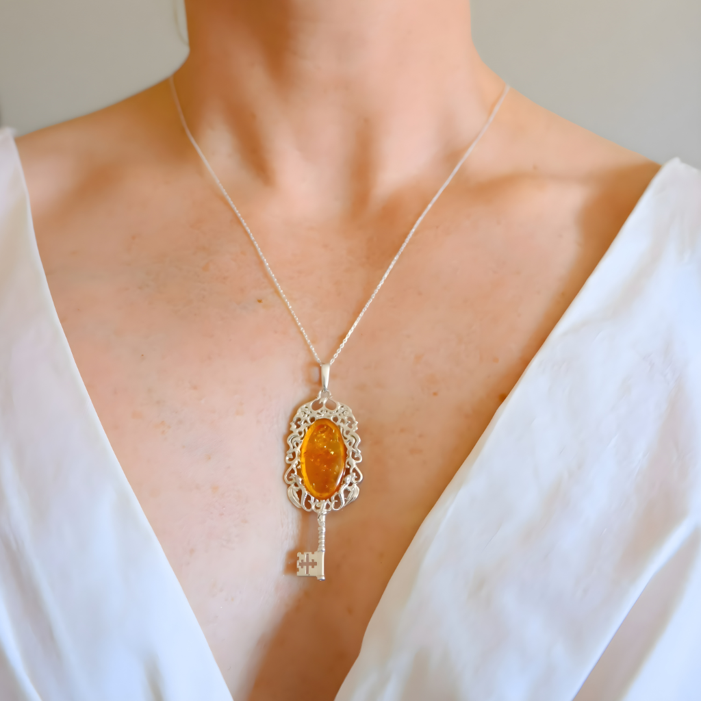 amber Necklace with a key-shaped pendant featuring an amber stone on a white background