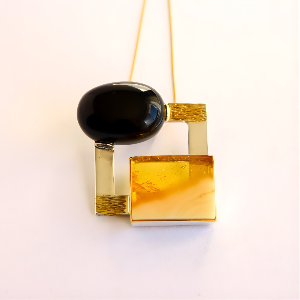 amber Necklace with black and gold pendant on a white background
