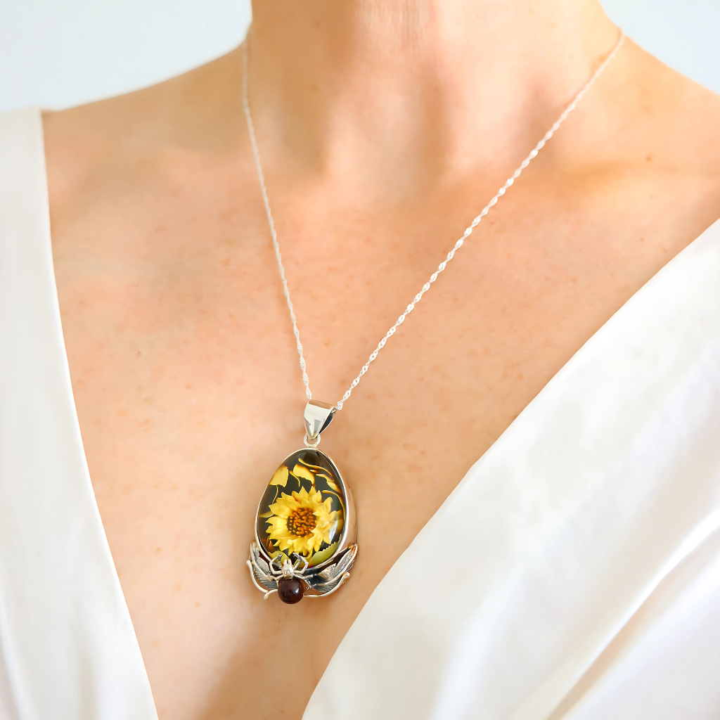 Amber Necklace pendant featuring a sunflower on a white background