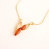 Gold amber necklace with amber-colored pendant on a white background