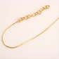Gold chain amber necklace on a light beige background