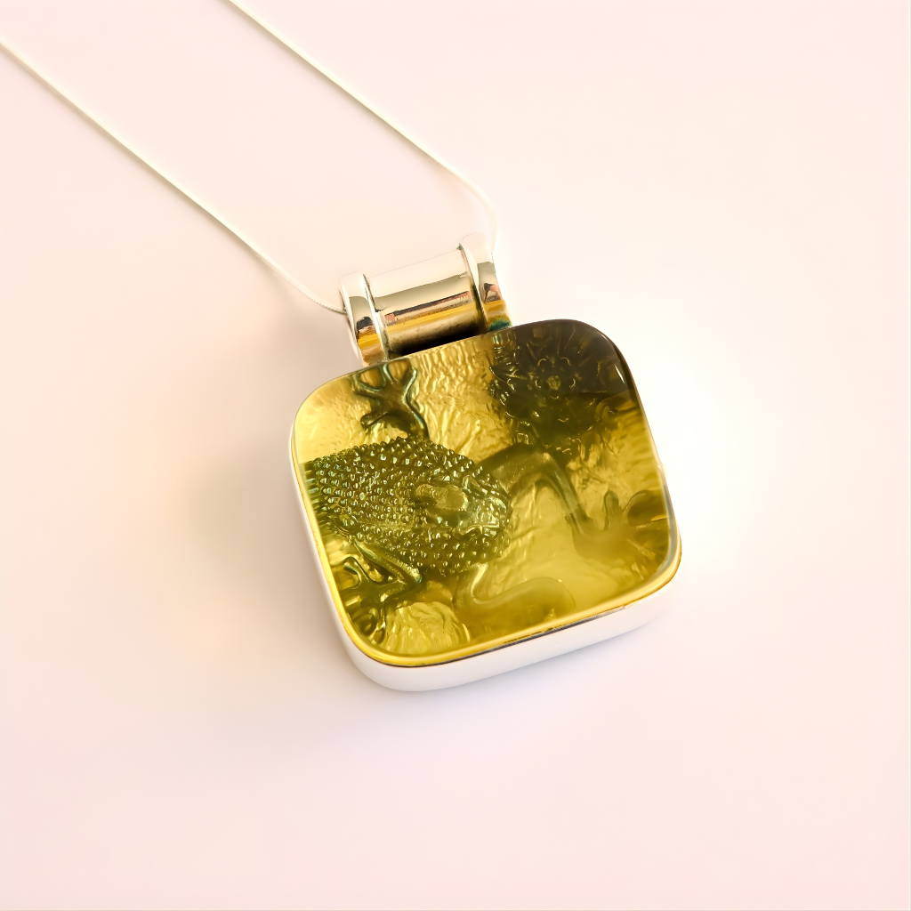 green amber necklace on a light pink background