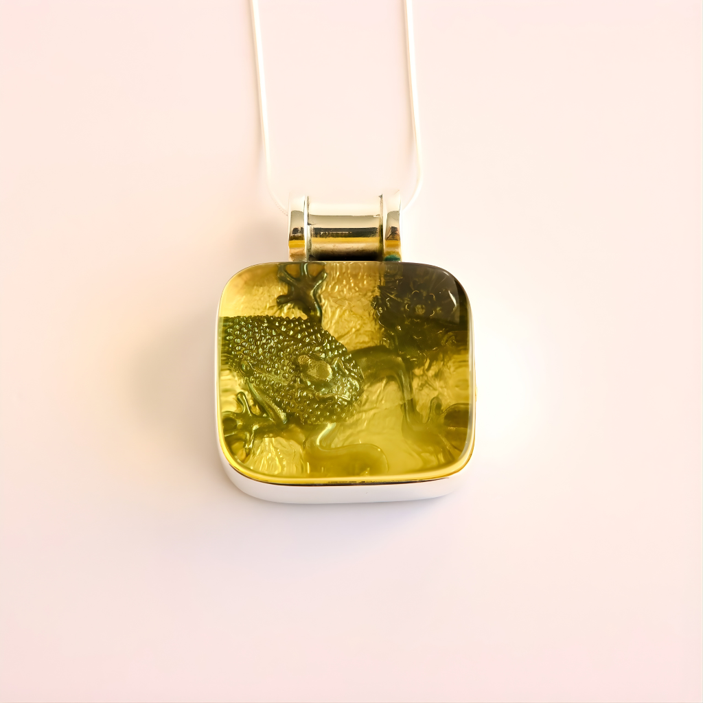 green amber necklace on a light pink background