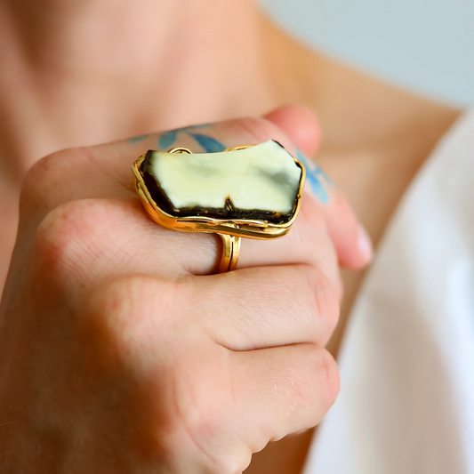 Adjustable Baltic amber statement ring featuring bold white and black amber stones