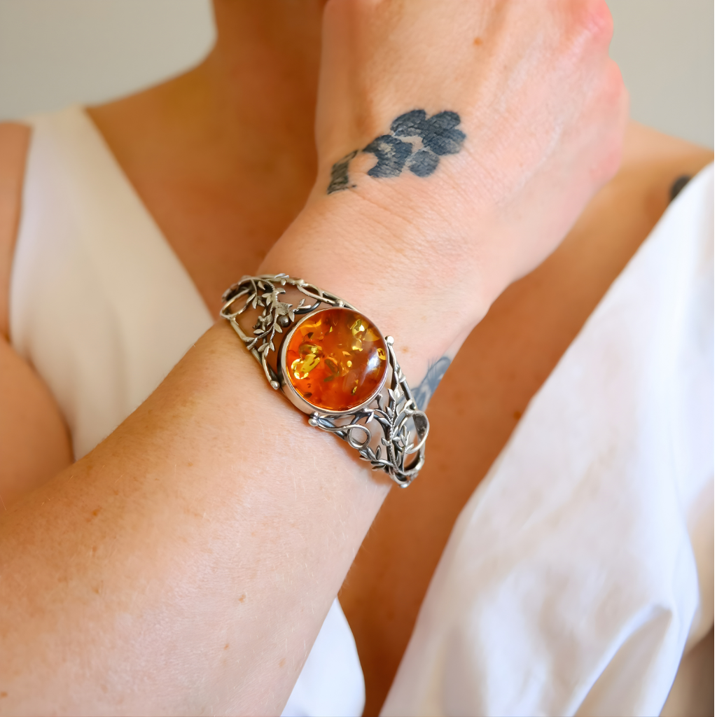 sterling Silver bracelet with a amber stone on a wrist with a tattoo