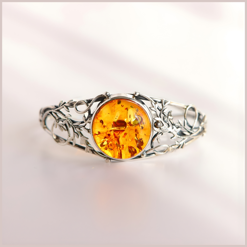 sterling Silver bracelet with a large amber stone on a light background