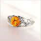 sterling Silver bracelet with a large amber-colored gemstone on a light background
