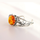 sterling Silver bracelet with a large orange gemstone on a light background