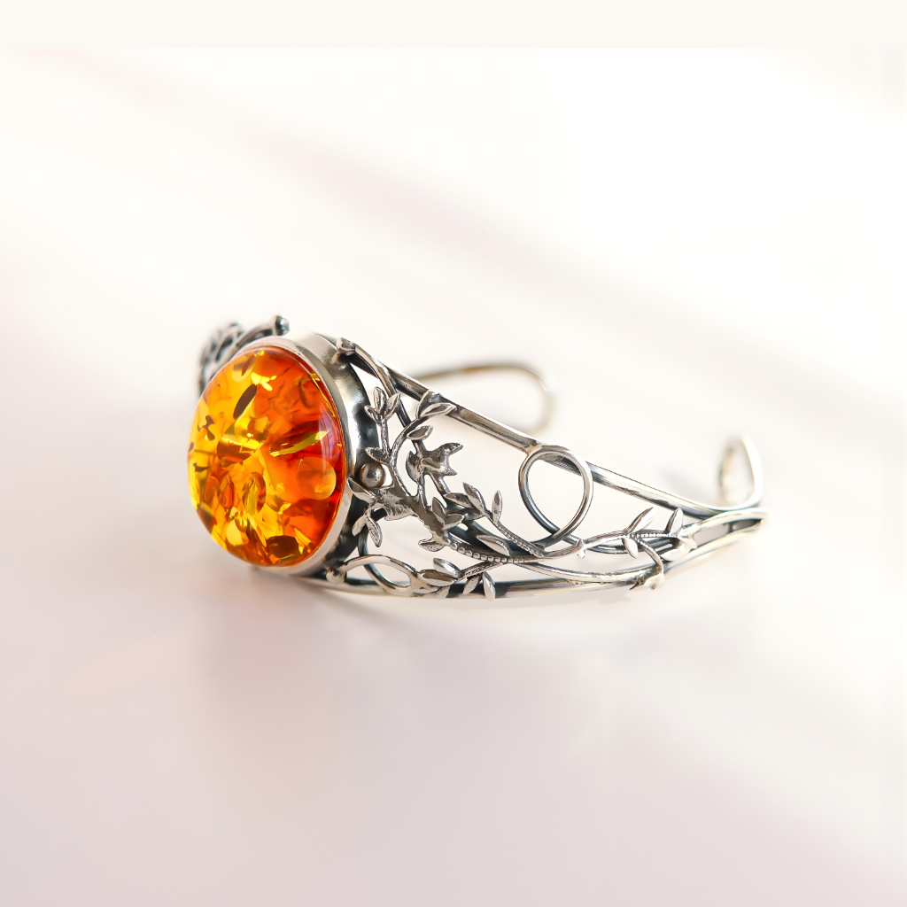 sterling Silver bracelet with a large orange gemstone on a light background