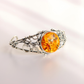 sterling Silver bracelet with a large amber stone on a light background
